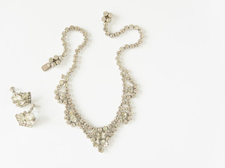 Woman's Jewelry. Vintage jewelry background. Beautiful clear rhinestone necklace and earrings set...