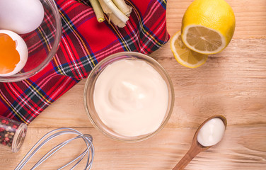 Mayonnaise on a wooden background. Ingredients mayonnaise