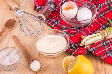 Mayonnaise on a wooden background. Ingredients mayonnaise