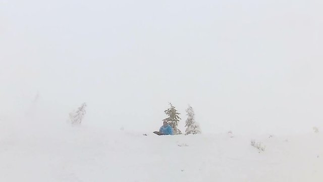 Snowboarder crashing into tree, performing crazy extreme trick, man having fun
