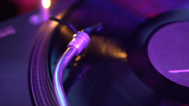 Vinyl record turning on DJ sound equipment, soundtrack playing