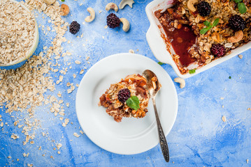 Freshly baked diet berry crumble with oatmeal with fresh berries blackberries decorated with mint...
