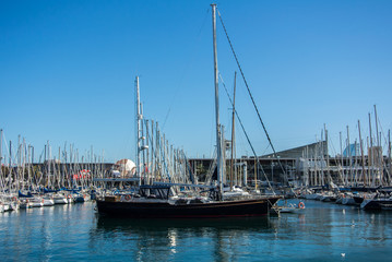 Fototapeta premium BARCELONA, SPAIN - FEBRUARY 12, 2014: A view to a pier with yachts at Barcelona port, Catalonia, Spain.