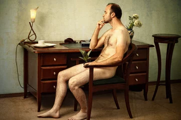 Tuinposter handsome naked man sitting thoughtful in the chair © Ruslan Solntsev