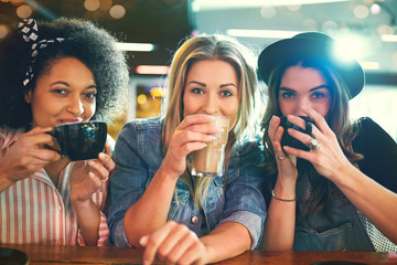 Young women sipping coffee