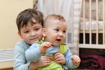 Two young brothers hugging