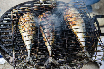 Grilled Fish are being prepared outside
