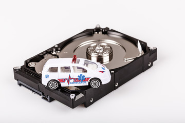 Fototapeta premium ambulance car on harddrive or hdd - data rescue concept