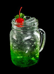 green sparkling soda on dark black ground