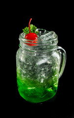 green sparkling soda on dark black ground