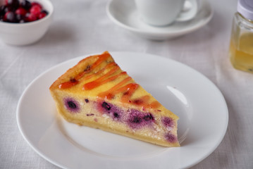 Slice of the New York cheesecake with berries on a white plate