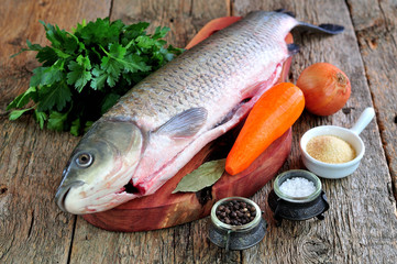 Fresh raw shelled carp with onions, carrots, parsley, salt and pepper.