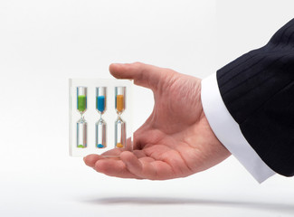 Hourglass in hand businessman on a white background