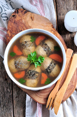 Jellied stuffed fish on the old wooden background.