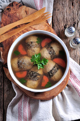 Jellied stuffed fish on the old wooden background.