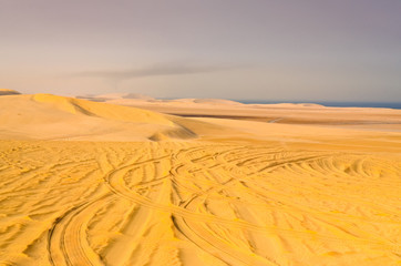 Fototapeta na wymiar Detail of tyre tracks in sand desert