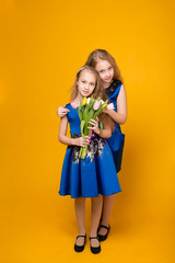 Two beautiful young girl with a bouquet of flowers