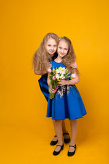Two beautiful young girl with a bouquet of flowers