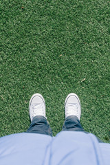 Artificial turf grass on soccer field with two shoes