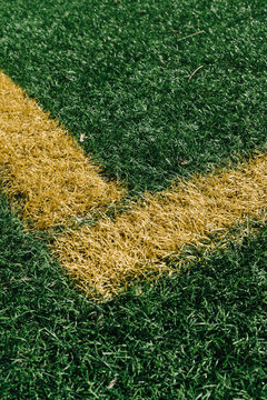 Yellow corner on sports field with artificial grass