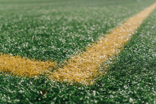 Yellow corner on football field with artificial grass