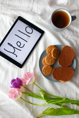 sweets,tablet and tulips.  Women's day, Mother's Day.