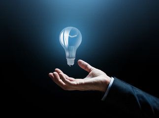 close up of businessman hand with light bulb