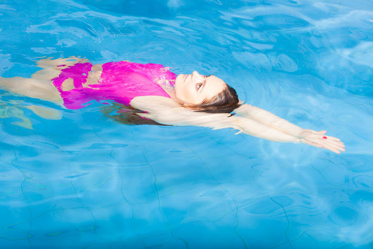 Beautiful woman swimming in pool