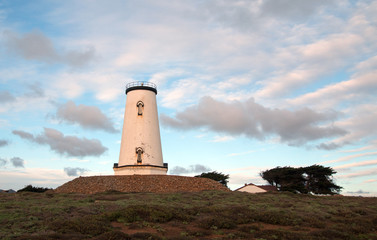 Lighthouse at Piedras Blancas point under cumulus sunset cloudscape on the Central California Coast north of San Simeon California USA