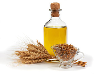 Glass bottle with Olive Oil, Ears of Wheat and Sprouted Wheat on a White Background