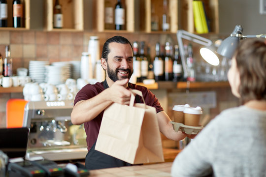 man or waiter serving customer at coffee shop