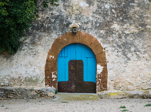 Blue wooden door in the old Spanish rural house