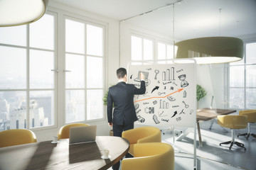 Man drawing business icons