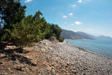 Fototapeta na wymiar Pebble beach with turquoise lagoon near Paleochora town on Crete island, Greece