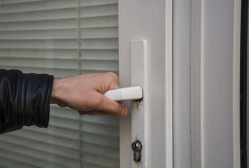 Male hand opens the plastic door to the room