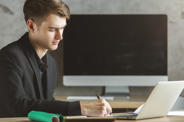 European man using notebook