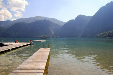Travel to Attersee, Austria. The view on the lake with the mountains on the background in the sunny day.