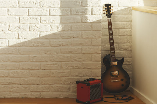 Guitar in brick room