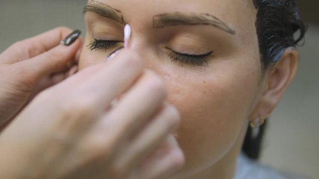 Young woman with hair in the paint, to eyebrow make-up sitting from the master image maker beauty salon ultra HD