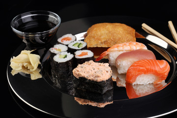 close up of sashimi sushi set with chopsticks and soy - sushi roll with salmon and sushi roll,...