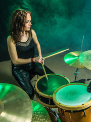 Woman playing drums onstage