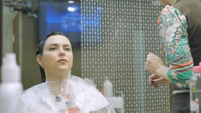 Young woman with hair in the paint, to eyebrow make-up sitting from the master image maker beauty salon ultra HD