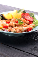 fresh shrimps served on a plate with garlic onion, lemon and chi