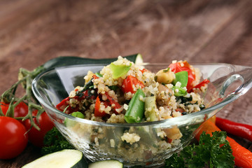 Delicious vegetarian quinoa salad with bell pepper, cucumber and tomatoes