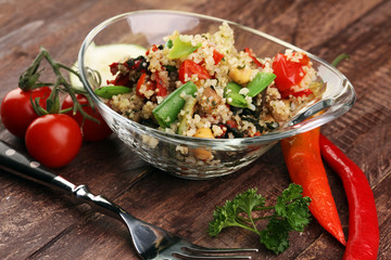 Delicious vegetarian quinoa salad with bell pepper, cucumber and tomatoes