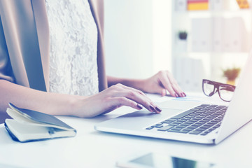 Fototapeta premium Close up of a woman typing at laptop
