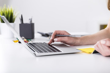 Close up of woman typing on laptop