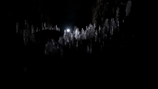 A scientist studying ice stalagmites in the cave