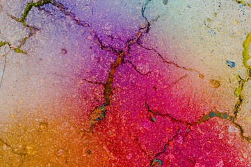Old asphalt cracked background texture painted with rainbow process