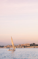 Landscape of Luxor with sailboat on Nile - river cruise on felucca.